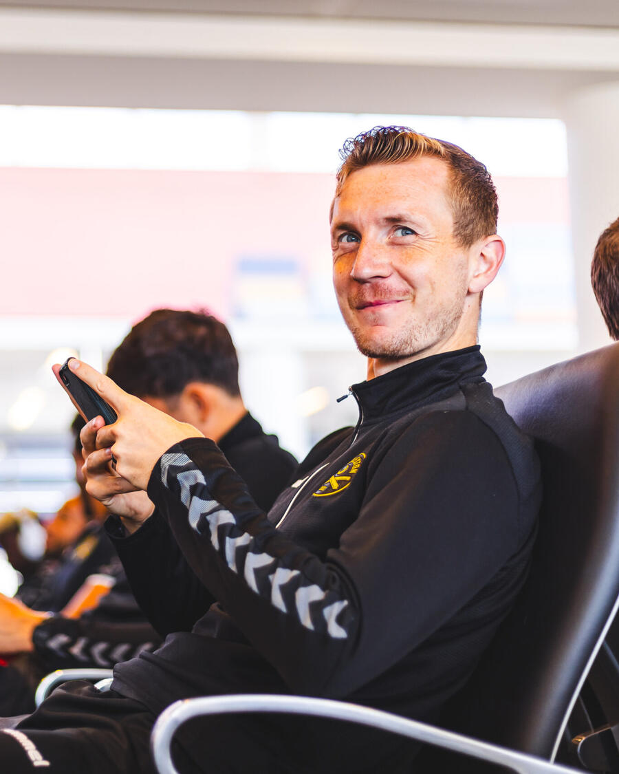 Robbie Crawford smiling while travelling with the team